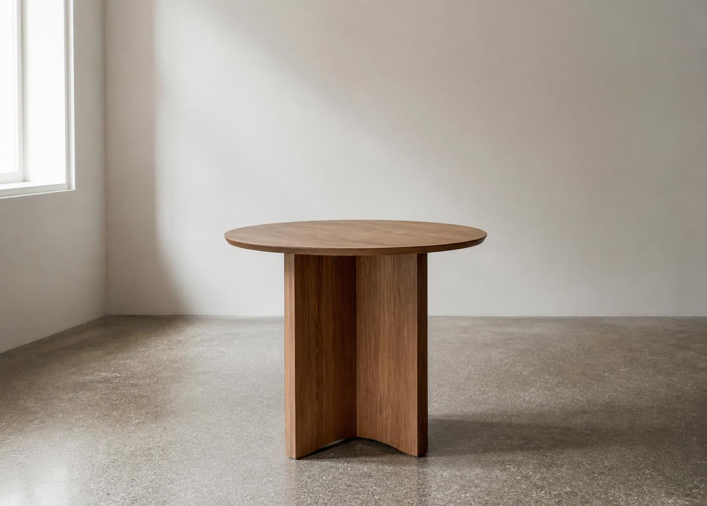 Round table with a wood-grain laminate top